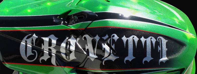 Green dirtbike helmet with stars and old school flames